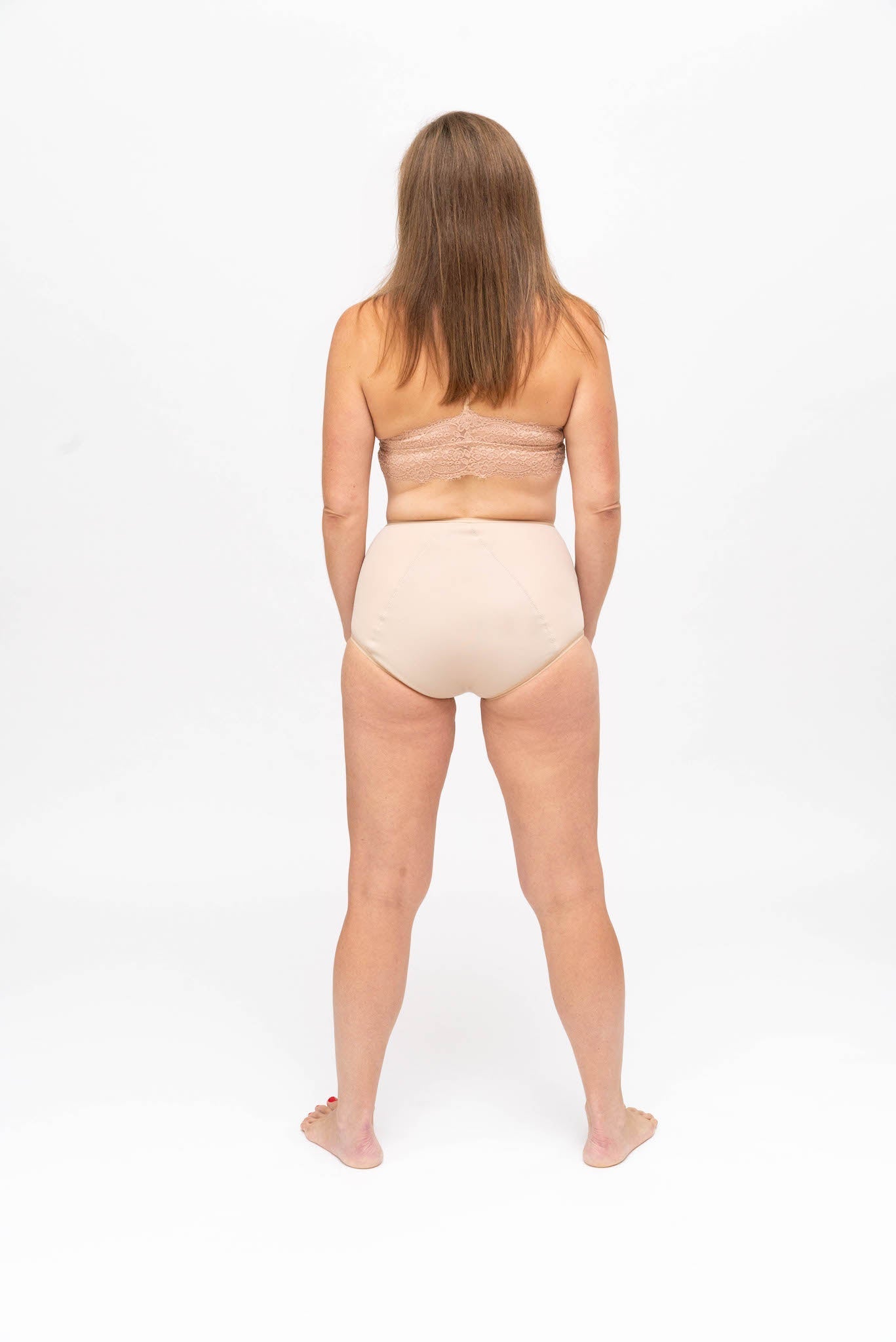 Full figure woman wearing a soft black bra and high waist brief